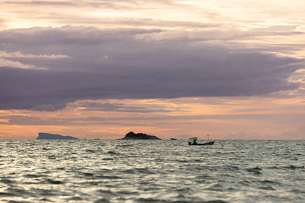 Sun is setting over by the sea at Ko Phangan Island, Thailand.