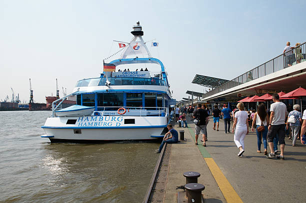 HAMBURG, GERMANY - AUGUST 14, 2015: Ferrys at Landungsbruecken jetty pier, Hamburg harbor
