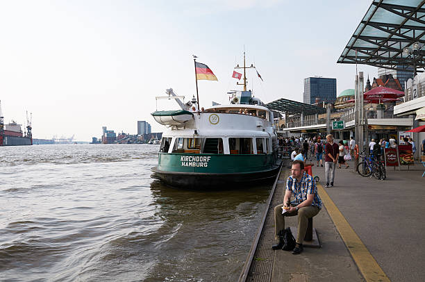 HAMBURG, GERMANY - AUGUST 14, 2015: Ferrys at Landungsbruecken jetty pier, Hamburg harbor