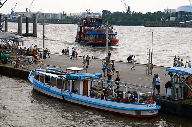 HAMBURG, GERMANY - AUGUST 14, 2015: Ferrys at Landungsbruecken jetty pier, Hamburg harbor