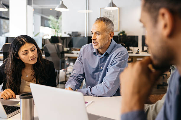 istock Business people collaborating on project in modern office 2244337748