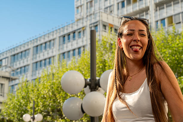 istock Young woman making a playful face outdoors on sunny day 2244338805