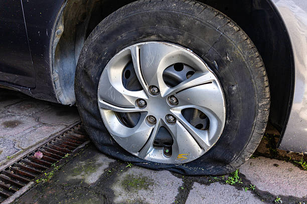 Flat and damaged tire parked in a house garage