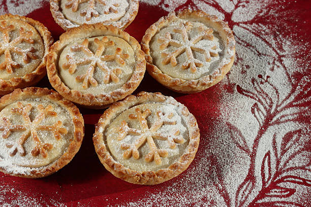istock Image of festive christmas mince pies with intricate snowflake pastry patterns, dusted with icing sugar / holiday tarts 2244340046