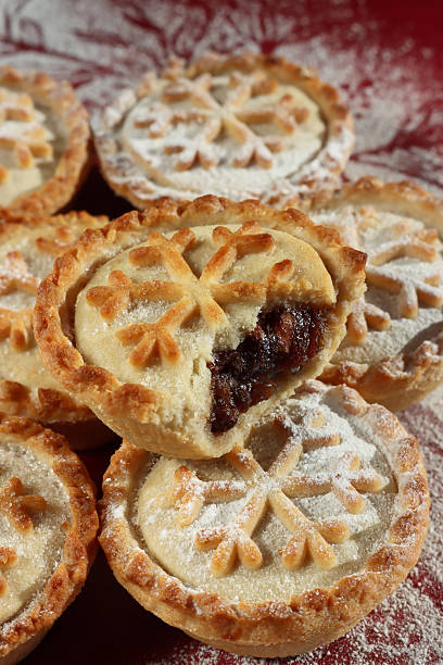 istock Image of golden christmas mince pies, snowflake pastry patterns, dusted with icing sugar / festive holiday tarts, snowy dessert decoration 2244340145