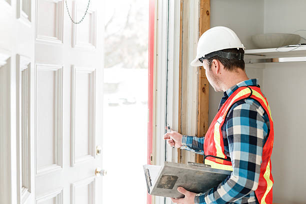 istock Inspector with white helmet inspecting an old house to be sure everything is well build 2244340247