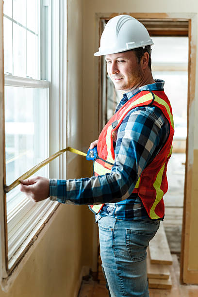 istock Inspector with white helmet inspecting an old house to be sure everything is well build 2244340311