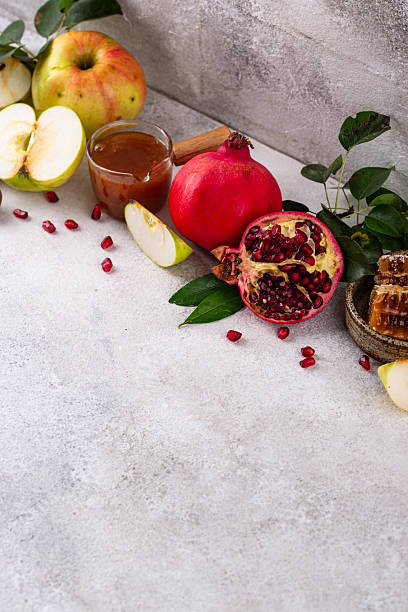 istock Rosh Hashana concept with honey, apple and pomegranate 2244340412