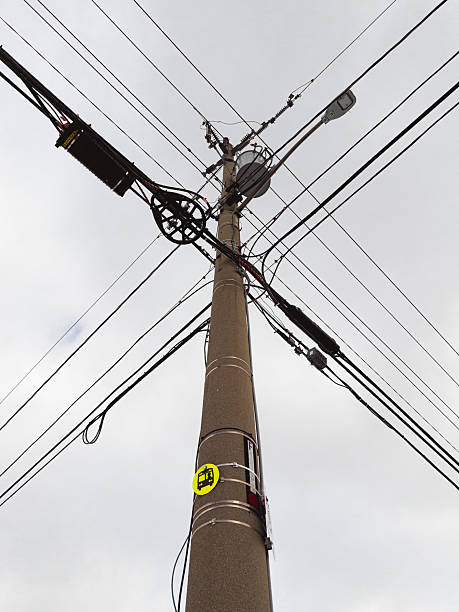 istock Low Angle View of Urban Utility Pole and Power Lines 2244340572