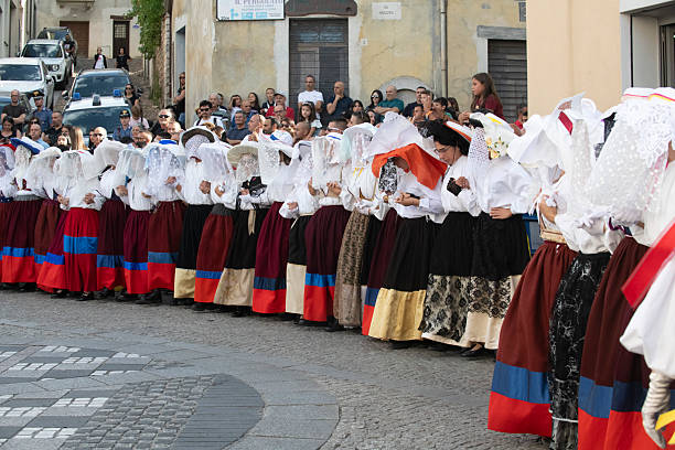 Women in a row playing  tambourines in the street, singing, wearing elegant historical clothing. Lugo city, Galicia, Spain during San Froilán autumn traditional celebrations.