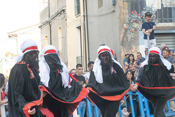 Rear view of folk dressed up women  multicolored folk traditional clothing in old town Lugo city, Galicia, Spain during San Froilán traditional celebrations.