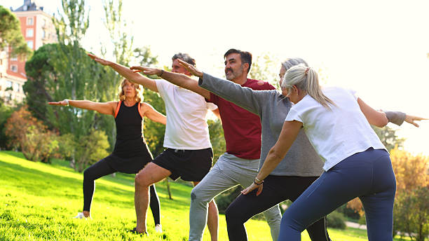 istock Seniors practicing yoga together in outdoor park 2244343769