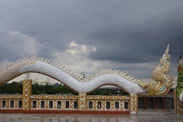 An ornate dragon sculpture atop a structure with Asian architectural elements