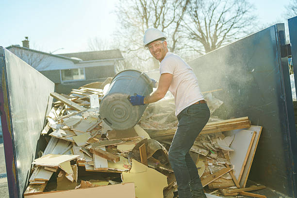 istock Construction Worker outside of house put old renovation material on big conteiner 2244344309