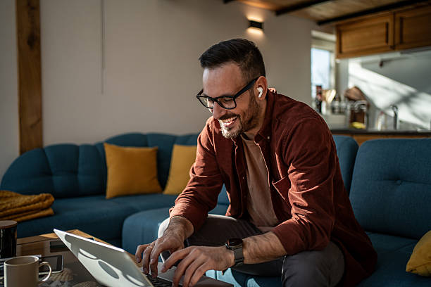 istock Happy man working remotely from home living room 2244344946