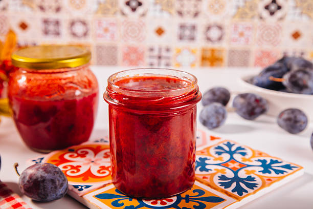 Glass jars of homemade jam and marmalade on shelf