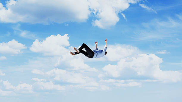 istock Man falling freely through the sky among clouds, concept of losing control, failure or sudden downfall, 3d render 2244345532