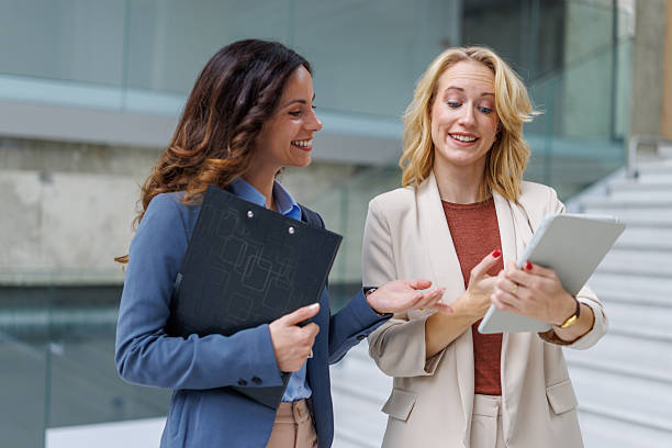 istock Businesswomen discussing project information on digital tablet 2244345792