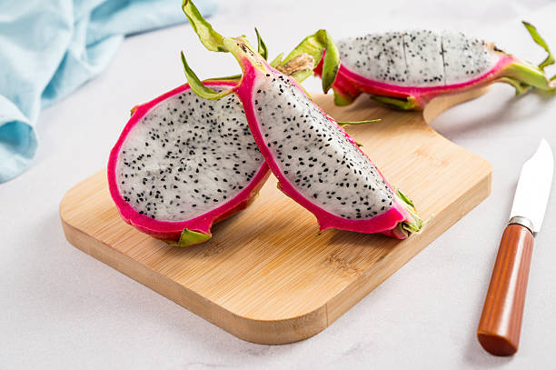istock Fresh Pitahaya pink dragonfruit slices. Exotic fruit on white background. 2244346452