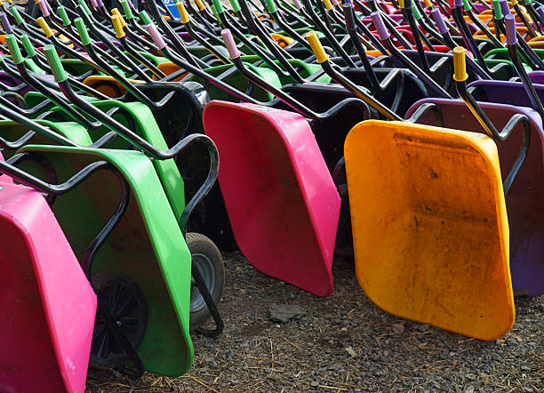 The orange wheelbarrow fallen on the side.