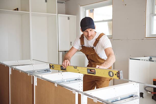 istock Carpenter Installing Luxury Modern Fitted Kitchen in house 2244347142