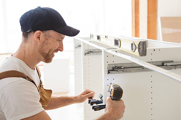 istock Carpenter Installing Luxury Modern Fitted Kitchen in house 2244347168