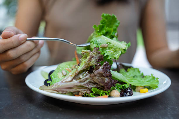 istock A Woman Enjoying Eating Fresh Green Salad 2244348036