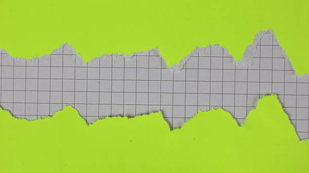 istock Yellow paper torn in two pieces with a checkered background 2244349790