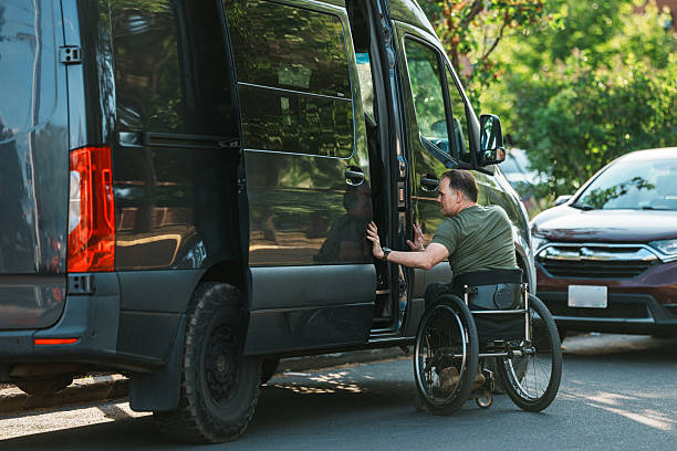 istock Man using a wheelchair opening van door 2244349849