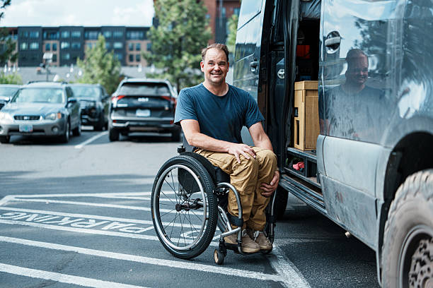 istock Man using wheelchair entering vehicle parked in accessible parking space 2244349926