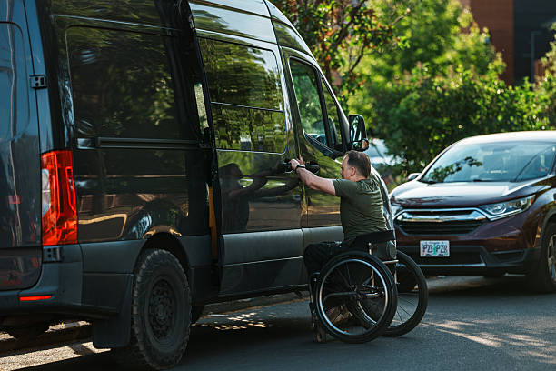 istock Man using a wheelchair opening van door 2244350008