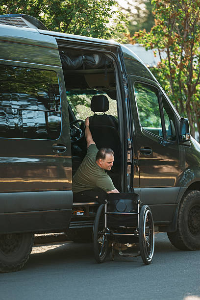 istock Man who uses a wheelchair getting into his van 2244350014