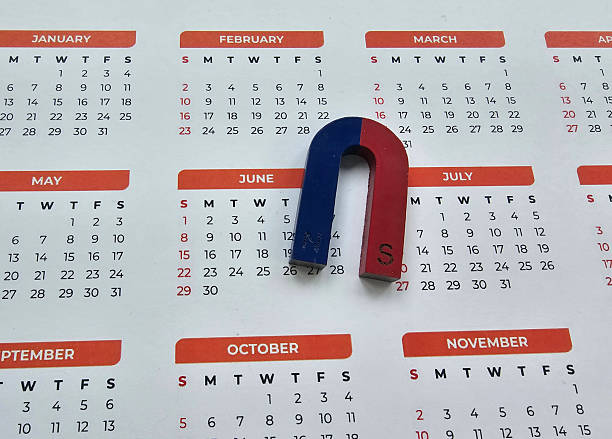 istock Magnetic red and blue U-shaped magnet placed on a calendar highlighting important dates concept 2244351360