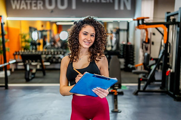 istock Personal trainer woman smiling posing at gym 2244351862