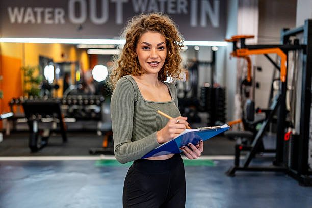 istock Personal trainer woman writing workout plan in gym 2244351884