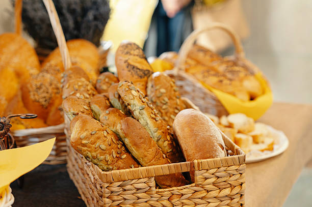 cozy breakfast scene, fresh baked rolls with jam, sunlit table with baked goods and coffee