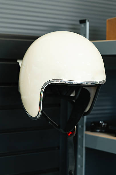 classic motorcycle headgear resting on storage stand with soft shadowing and nostalgic ambiance