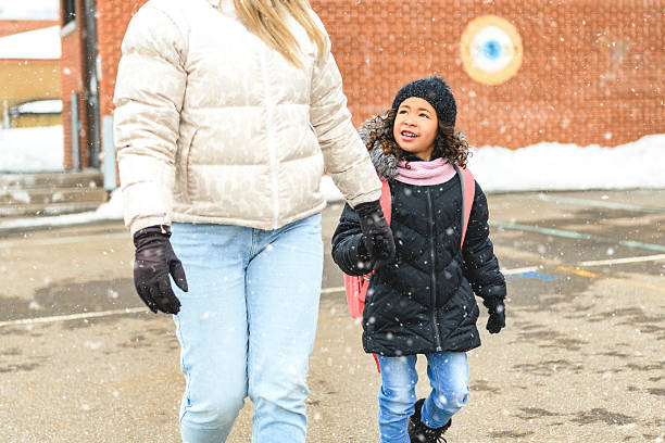 Black child going back to school with a backpack with mother
