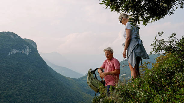 istock Mature couple relax on mountain ridge, Liguria 2244358977