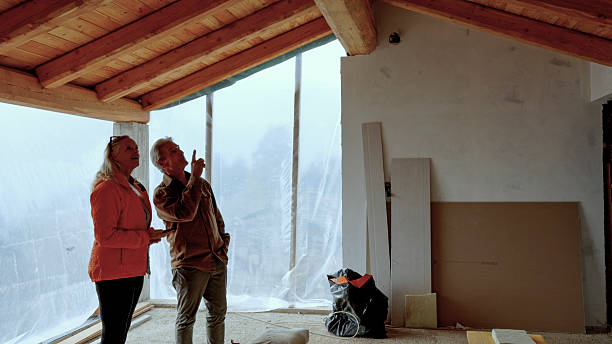 istock Mature couple inside new home construction 2244359473