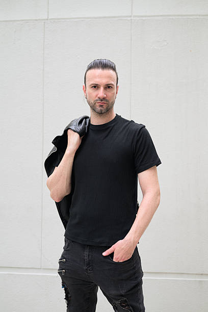 istock Portrait of handsome Italian man with beard against plain background 2244359698