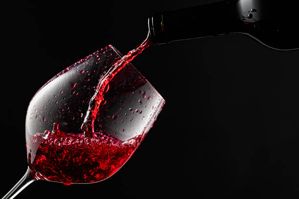 istock Red wine is poured from a bottle into a glass. 2244360891