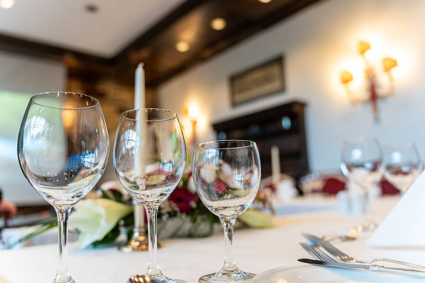 istock Fine dining table with flowers and glassware in soft light 2244363147