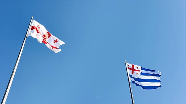 istock Flags of Georgia Fluttering in Wind on Sunny Day 2244363211