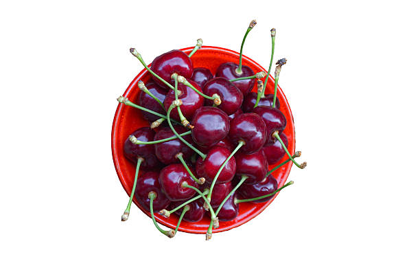Red cherries in a bowl on a white background