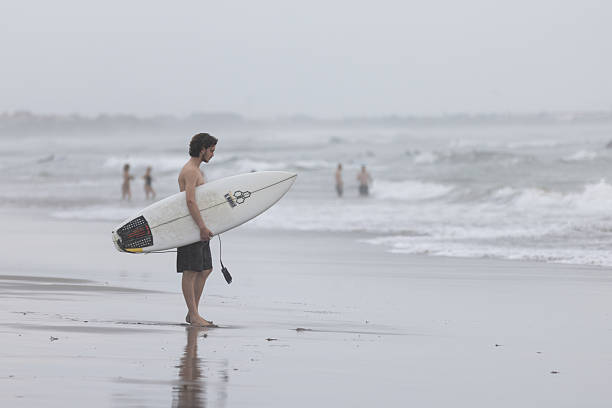 Surfer alone in the blue sea on a clear day