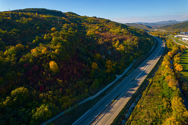 istock Scenic autumn highway winding through a colorful forest 2244368267