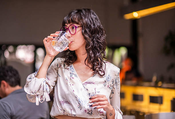 istock young woman enjoying a drink in a comfortable and modern restaurant 2244369133