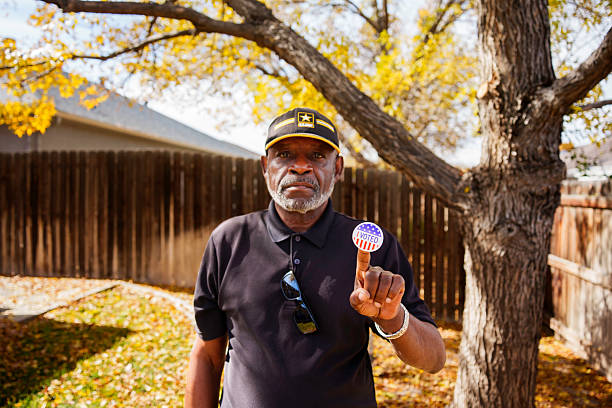 istock Senior man with “I Voted” sticker outdoors 2244369308