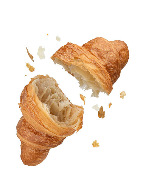 istock Torn falling croissant with crumbs on white isolated background 2244370361